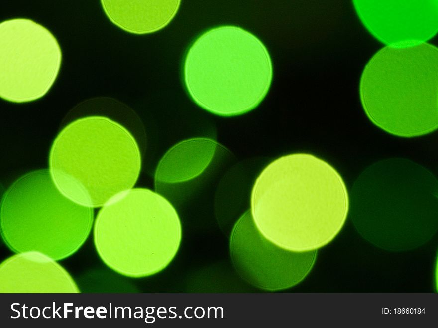 Green lights on a dark background to blur