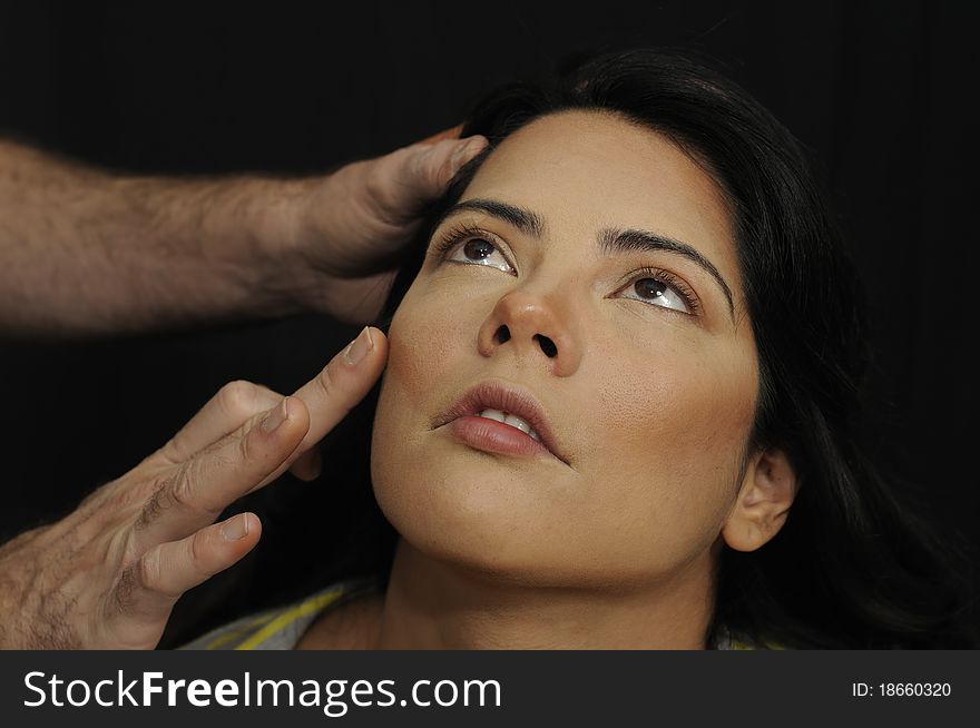 Proffesional make up being applied on hispanic girl face. Proffesional make up being applied on hispanic girl face