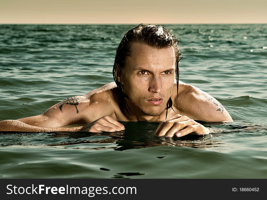 A young boy hiding in the sea water. A young boy hiding in the sea water