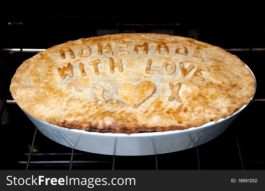 A home made pie with letters on. A home made pie with letters on.