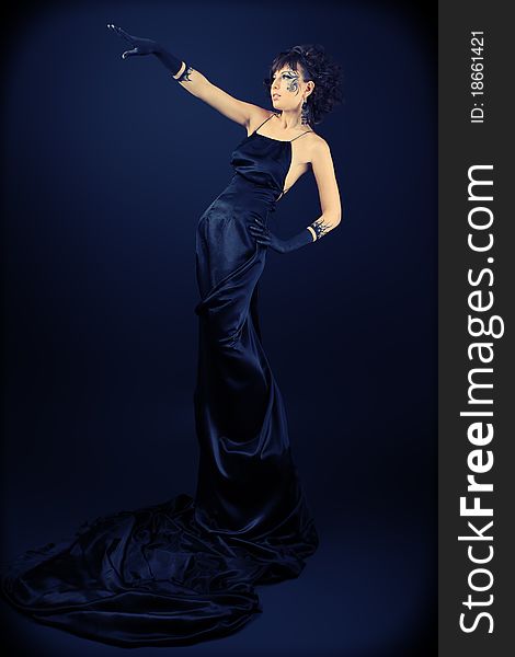 Beautiful fashionable woman in black dress. Studio shot. Beautiful fashionable woman in black dress. Studio shot.