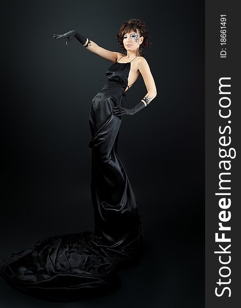 Beautiful fashionable woman in black dress. Studio shot. Beautiful fashionable woman in black dress. Studio shot.