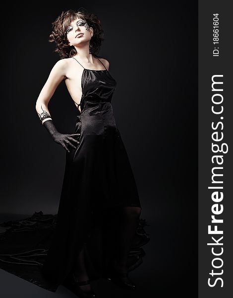 Beautiful fashionable woman in black dress. Studio shot. Beautiful fashionable woman in black dress. Studio shot.
