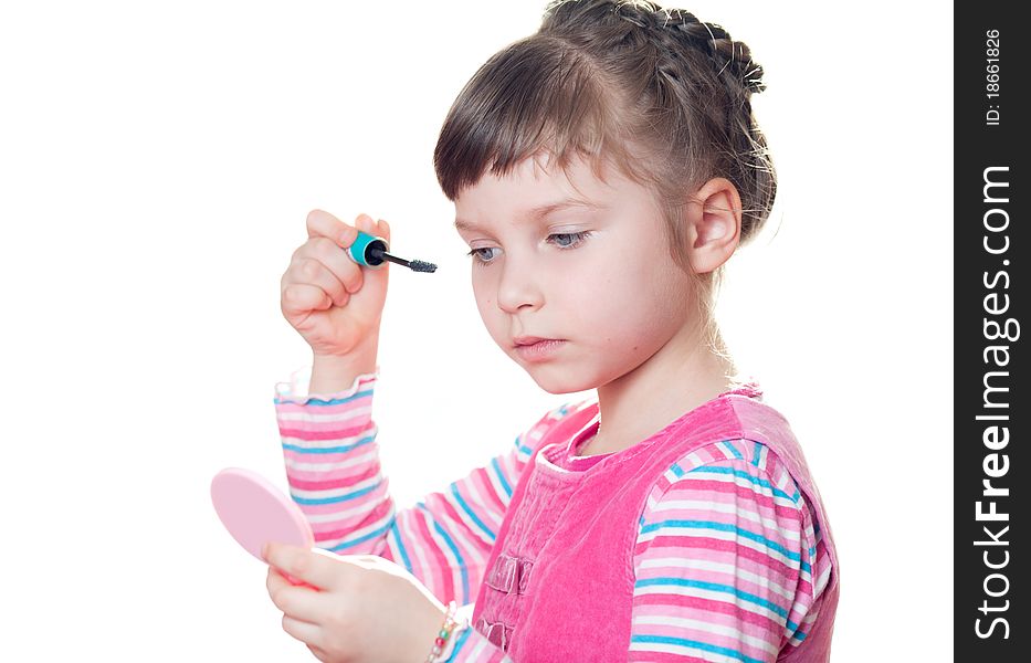 Young girl applies mascara. Isolated on a white background. Young girl applies mascara. Isolated on a white background.