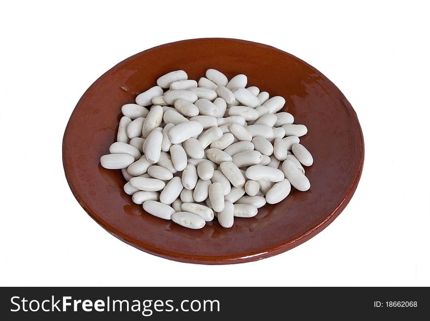 Raw white beans in small ceramic plate