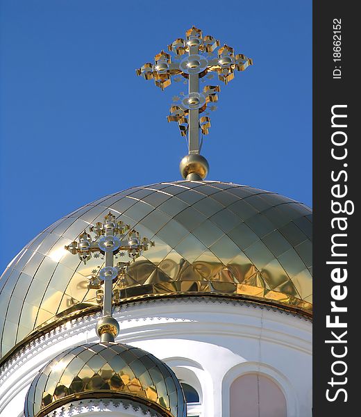 Two gilded dome orthodox church on background blue sky