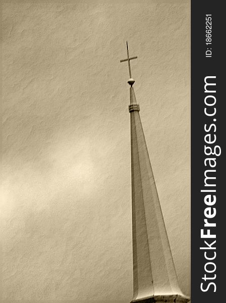 Church spire with cross in sepia on textured background