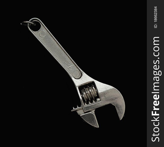 Steel adjustable wrench isolated on black background