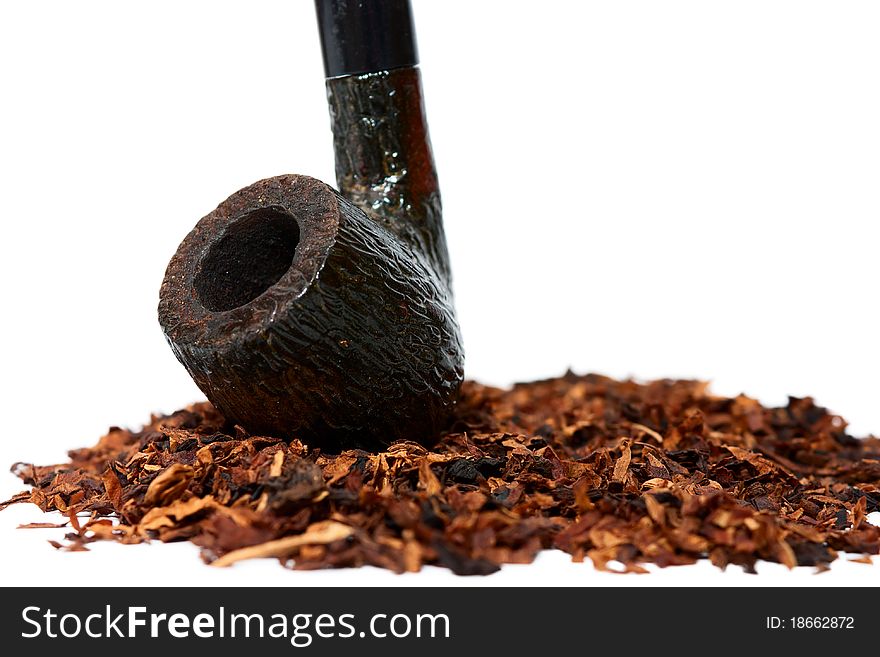 Dry tobacco and pipe isolated on white. Dry tobacco and pipe isolated on white