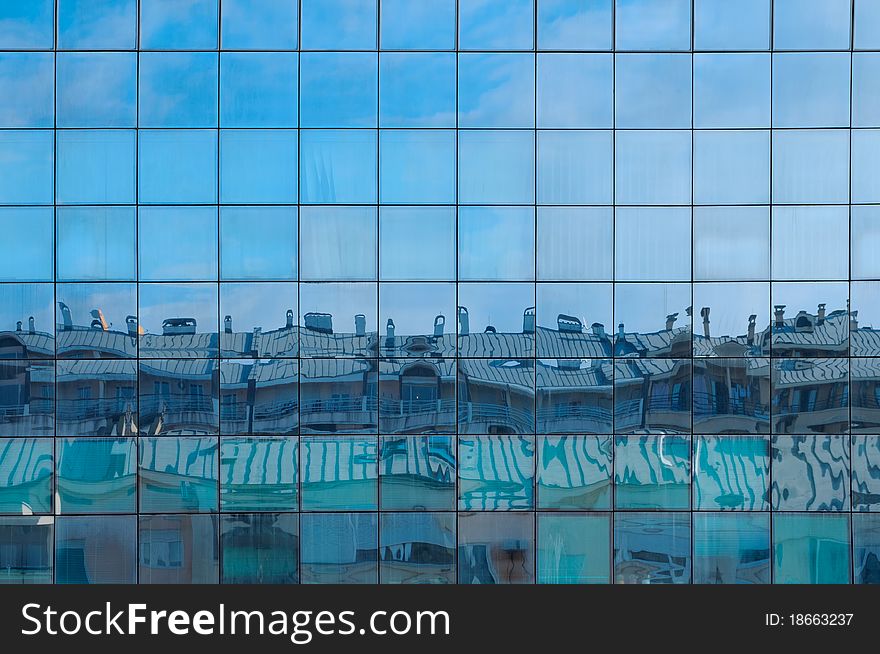 Abstract shapes from a modern building, with reflection of other buildings and sky. Abstract shapes from a modern building, with reflection of other buildings and sky.