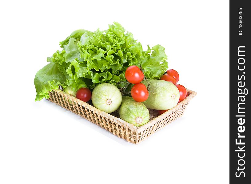 Vegetables are lying on tray from straw on a white background. Vegetables are lying on tray from straw on a white background