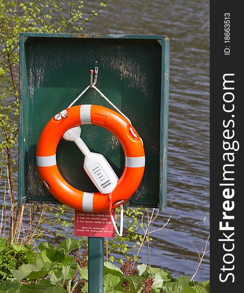 Life Buoy near water in its stand