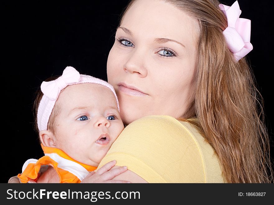 A closeup of a happy mom holding her precious baby.