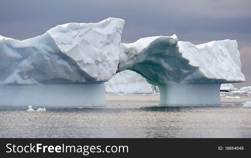 Arch iceberg in Antarctica ocean