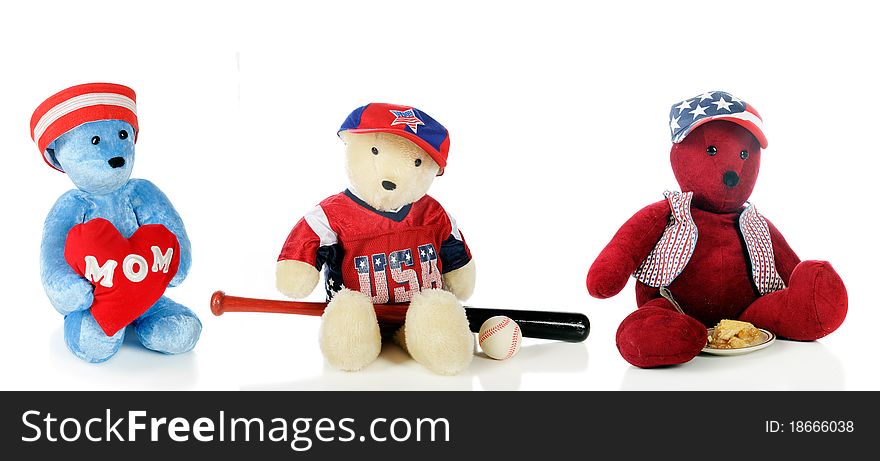 Three Teddy bears each with an emblem depicting the American way: love for Mom, baseball and apple pie. Isolated on white.