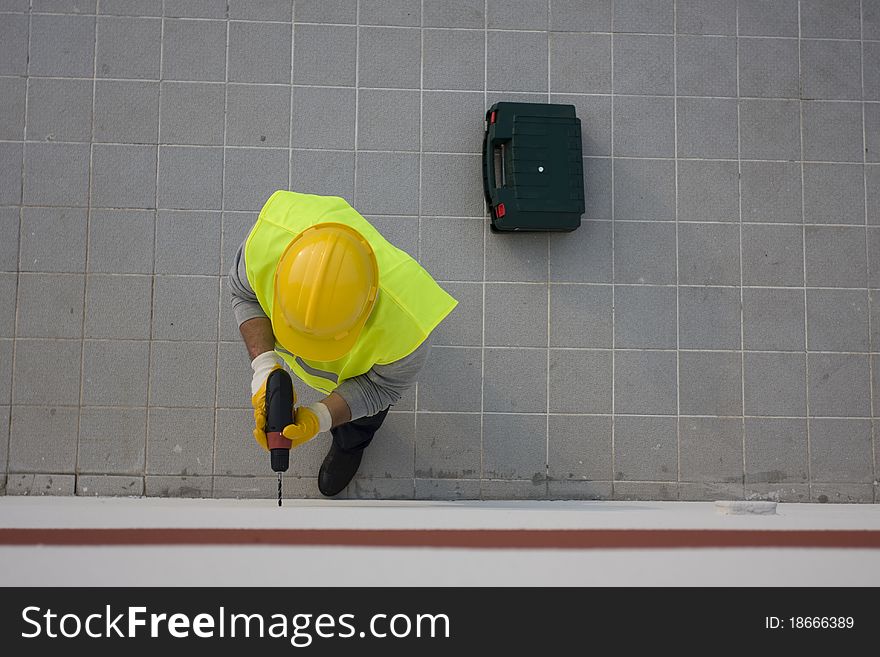 Man drilling a hole on a wall