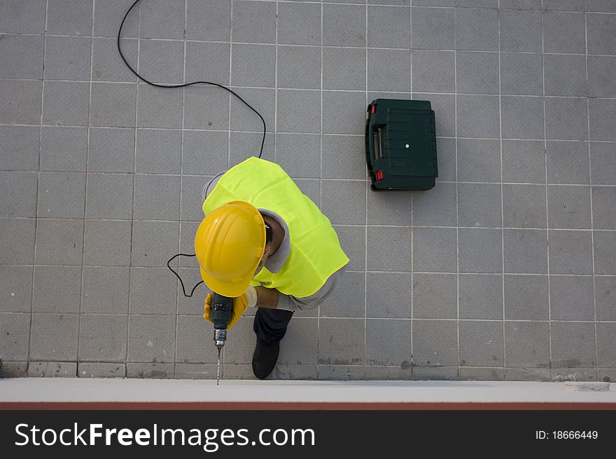 Man drilling a hole on a wall