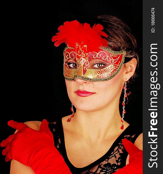 Portrait of beautiful young woman wearing red italian glows and mask. Shooting for black carnival. Portrait of beautiful young woman wearing red italian glows and mask. Shooting for black carnival.