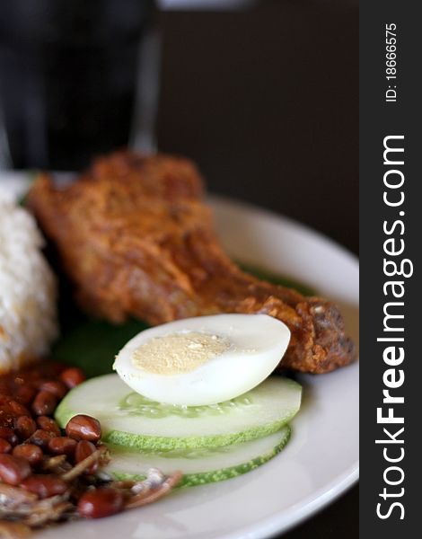 Rice boiled in coconut milk, accompanied by curry and sambal. Rice boiled in coconut milk, accompanied by curry and sambal