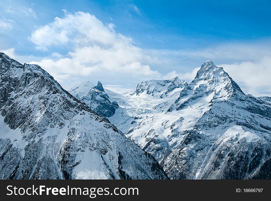 Snow-covered tops of the Caucasian mountains in Russia. Snow-covered tops of the Caucasian mountains in Russia.