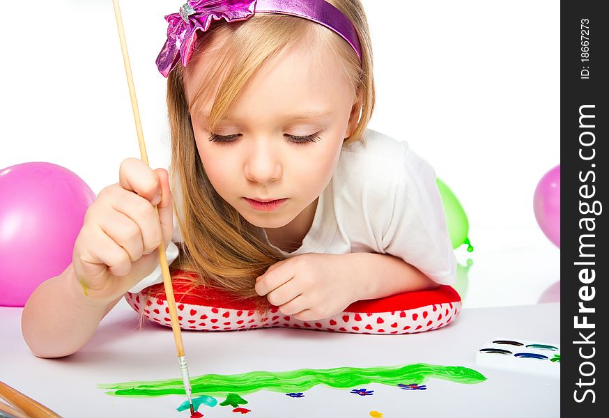Adorable little girl drawing artwork. Studio shot