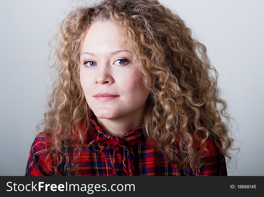 Portrait of beauty woman with blonde curly hairs with blue eyes