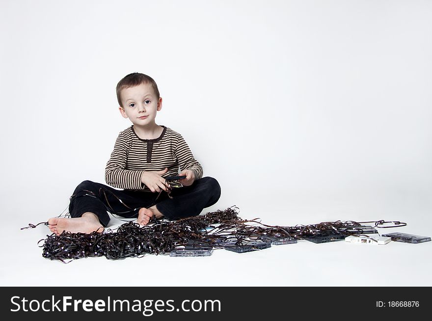 Portrait Of Cute Boy Playing With Old Tape