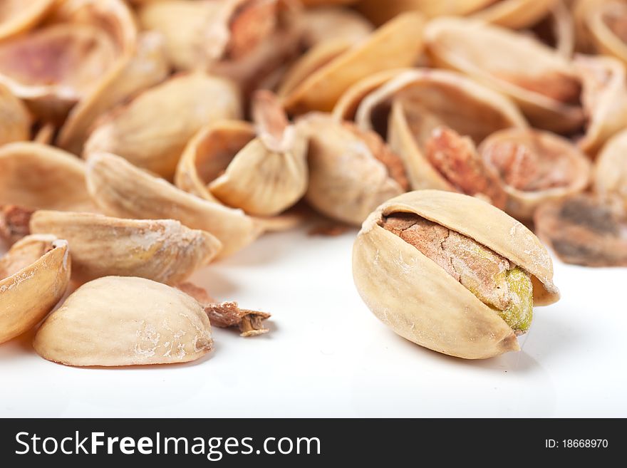 Macro view of last pistachio in the heap of nutshells