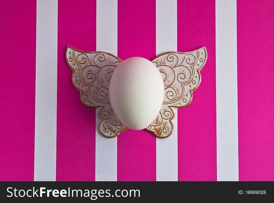 White easter egg on a striped background