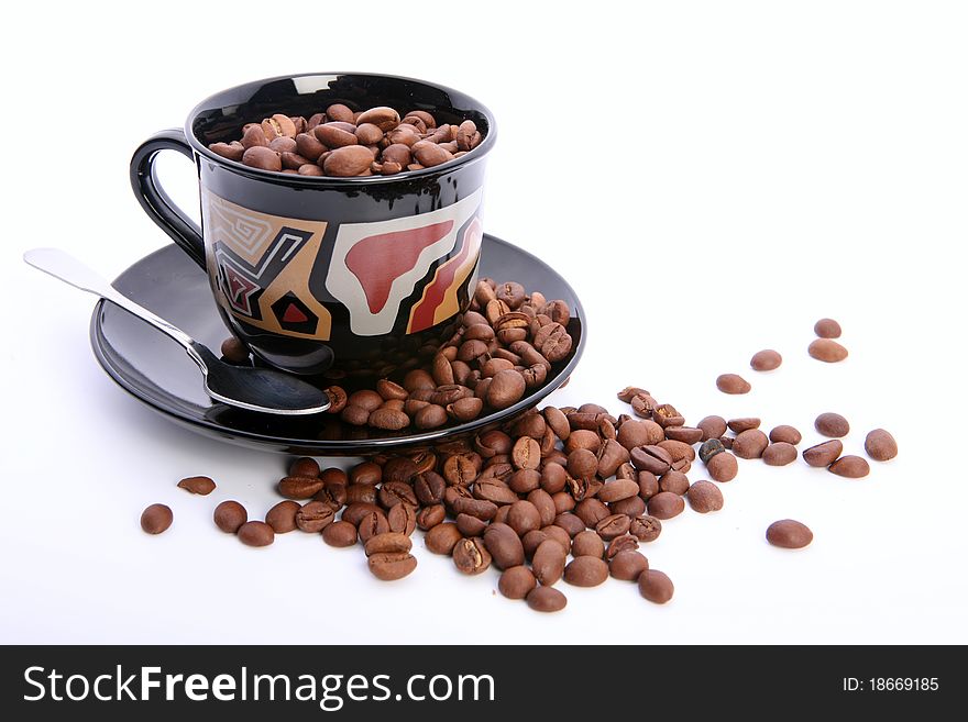 Cup of coffee with coffee grain with spoon