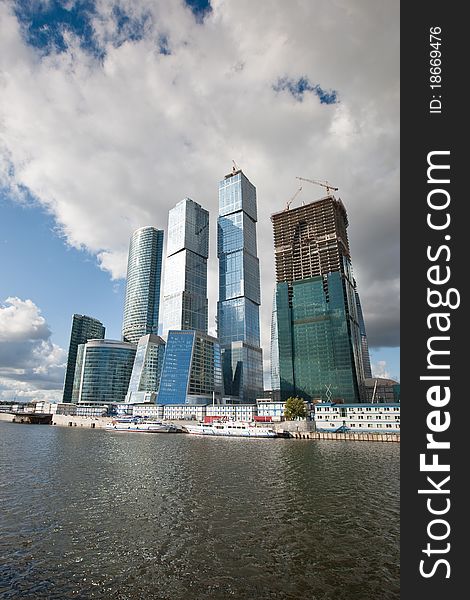 Many scyscrapers of Moscow city under blue sky with clouds