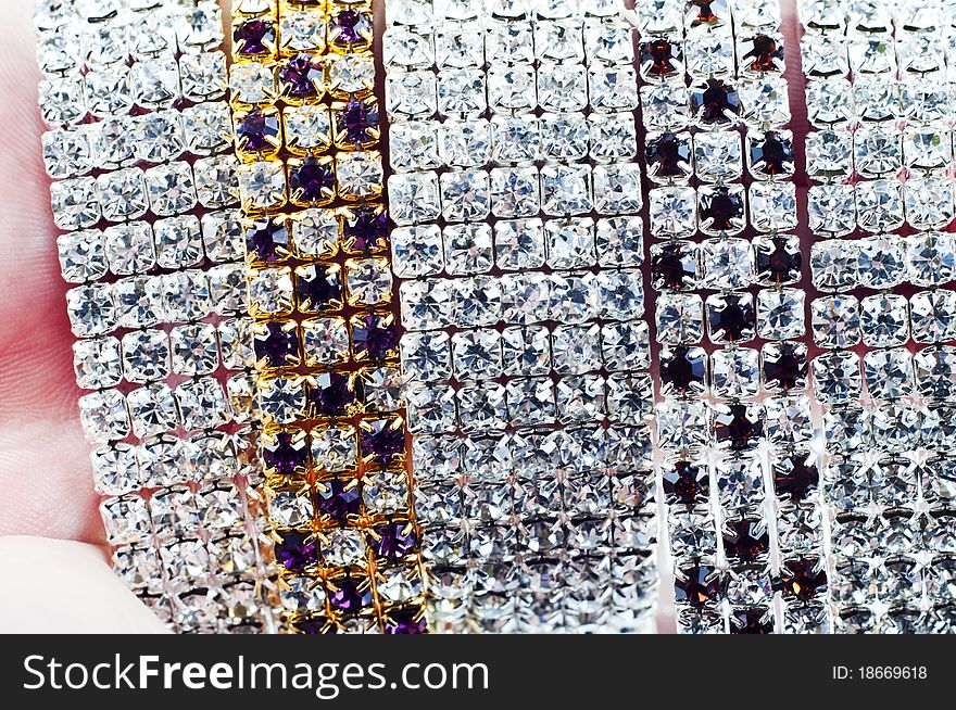 Bracelets in hand on white background