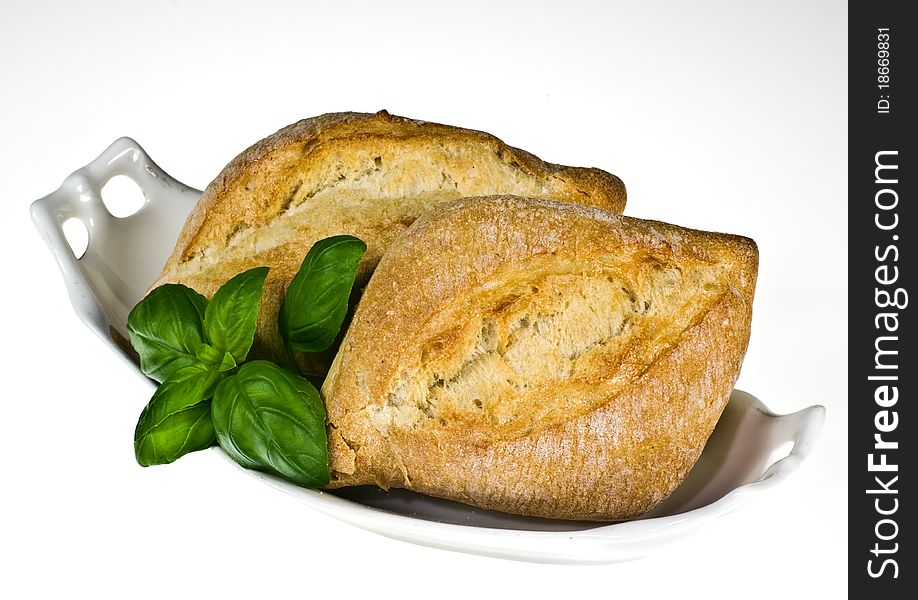 Ciabatta bread rolls on porcelain dish