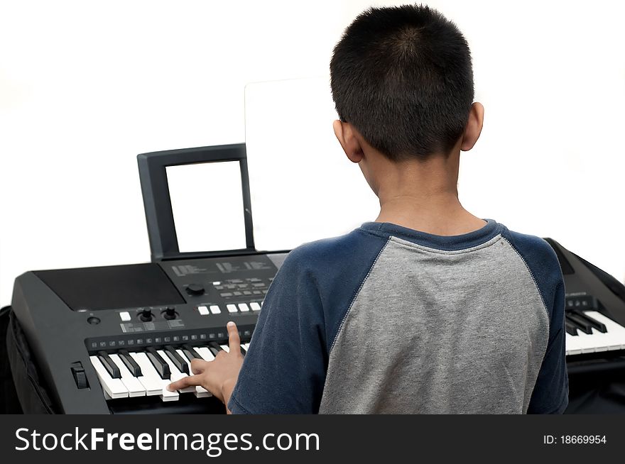 An handsome Indian boy learning music with an electric piano