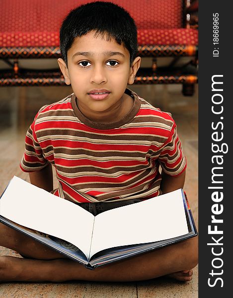 An handsome Indian boy learning music with an electric piano