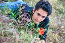 Young Man On The Grass With Flower Royalty Free Stock Photography Young Man On The Grass With Flower Royalty Free Stock Photography