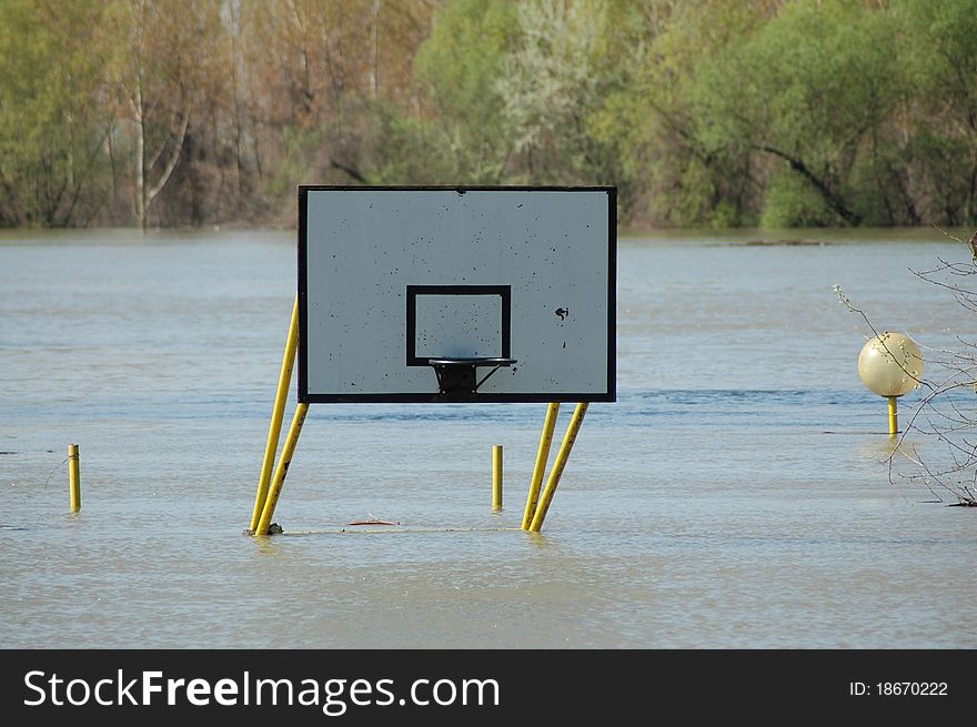 Flooded basketball court. basket under water