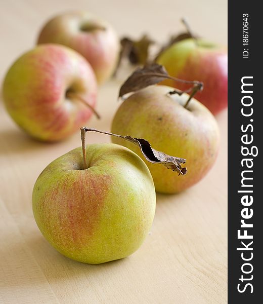 Fall fresh harvested apples on wooden board