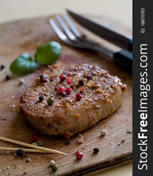 Juicy fillet steak with fresh basil and peppercorns