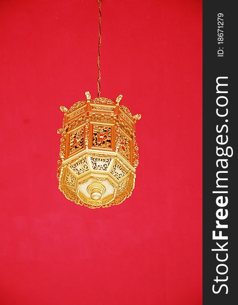 Image of gold lantern with red as background