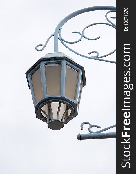 Image of lamp pole with white cloud as background