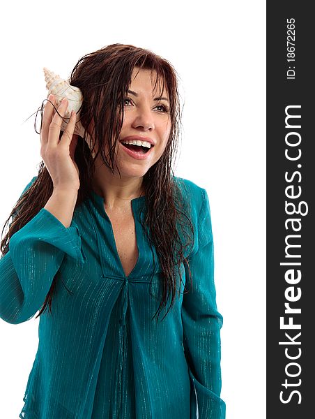 A beautiful woman with wet skin and hair holding a seashell to her ear and with a vivacious open smile. A beautiful woman with wet skin and hair holding a seashell to her ear and with a vivacious open smile.