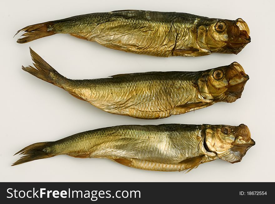 Three dried aringa fish isolated on white