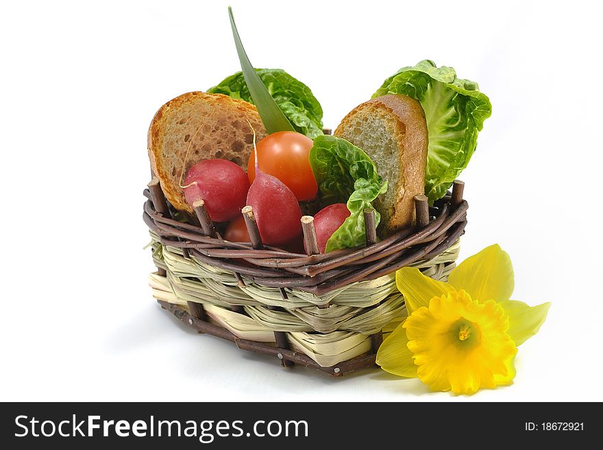 Basket of fresh vegetables and yellow flower