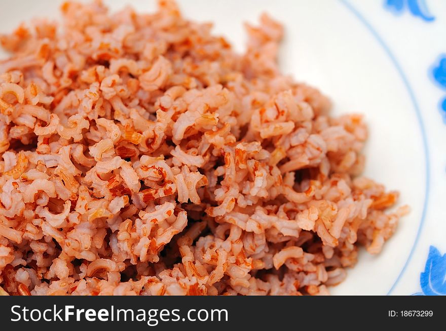 Healthy red unpolished rice commonly found in an Asian diet. Unpolished rice is known for its abundant minerals, vitamins, and soluble fiber.