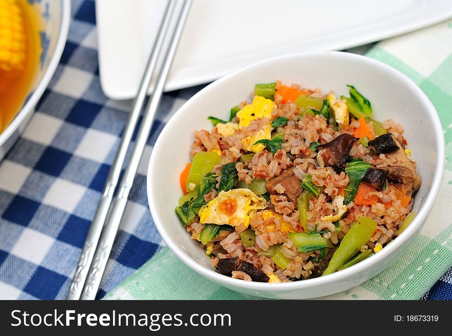Delicious Oriental fried rice from red unpolished rice mixed with healthy vegetables. Delicious Oriental fried rice from red unpolished rice mixed with healthy vegetables.