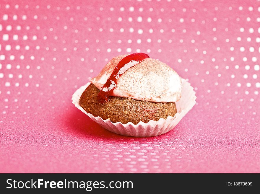 Beautiful little cake on colorful wallpaper background