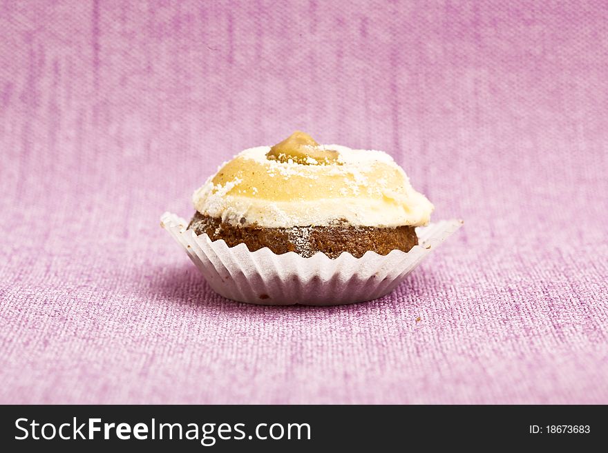 Beautiful little cake on colorful wallpaper background