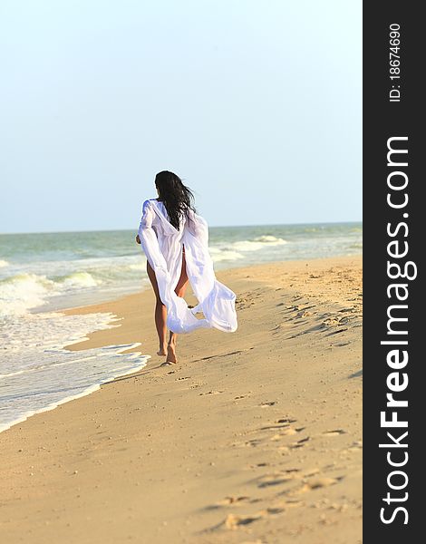 The Girl In White Coat At The Beach
