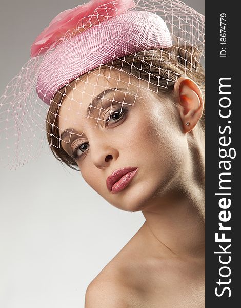 Portrait of pretty young woman in pink bonnet with voile. Vintage Make-up